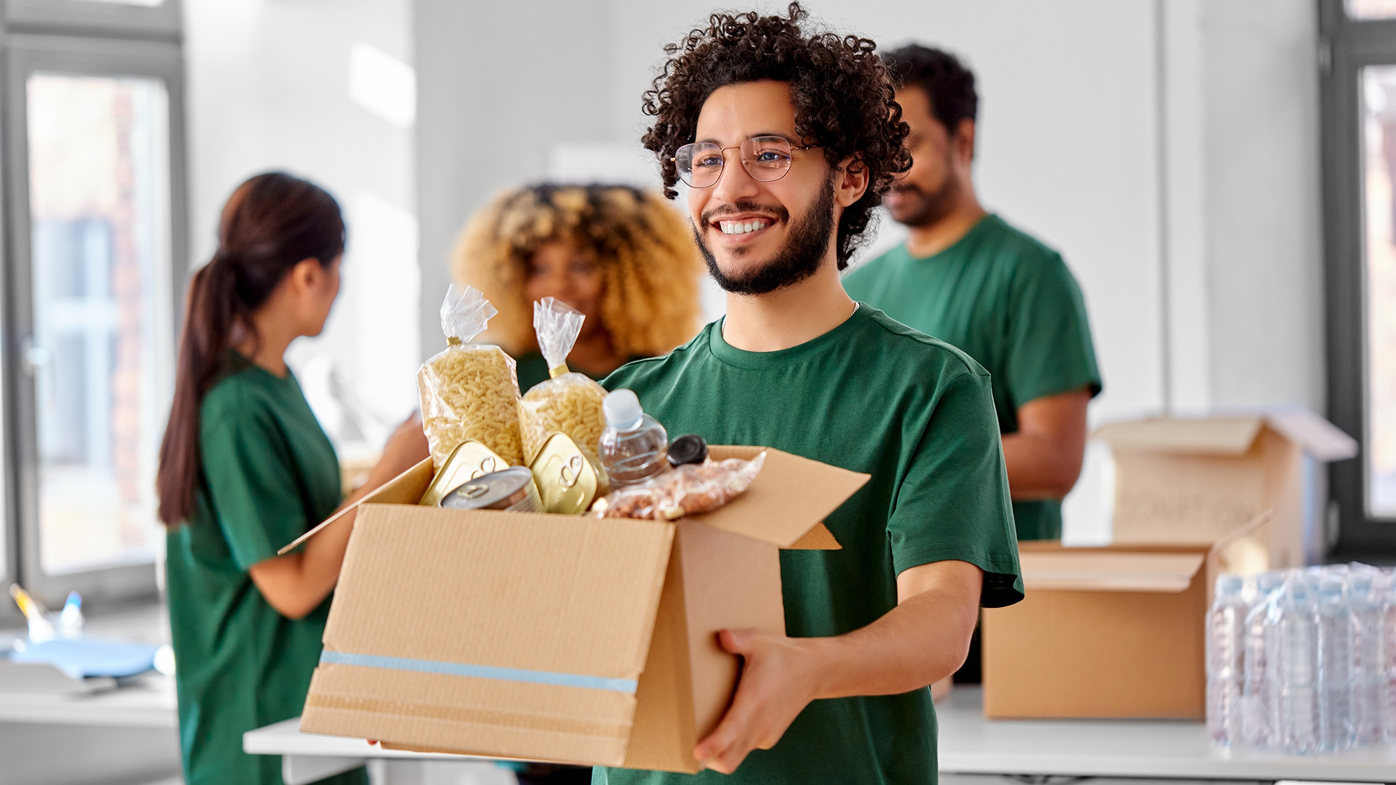 Man Smiling While Distributing Food