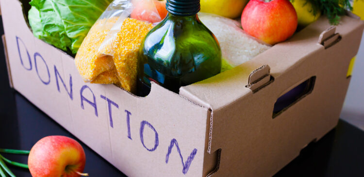Box full of donated produce and groceries