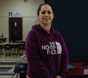 A woman, Corinne, stops for a smile while visiting the St. Mary of the Bay Food Pantry in Warren, Rhode Island.