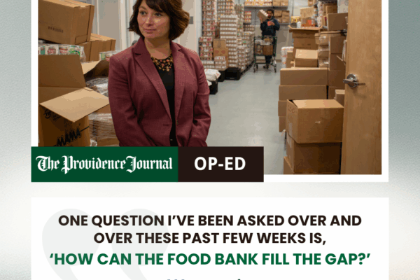 RI Food Bank CEO Melissa Cherney in a member agency's food storage room, looks at someone off-camera